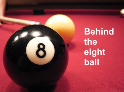The meaning and origin of the expression 'Behind the eight ball'.